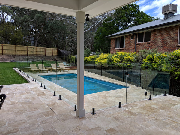 frameless glass pool fencing installed around outdoor swimming pool