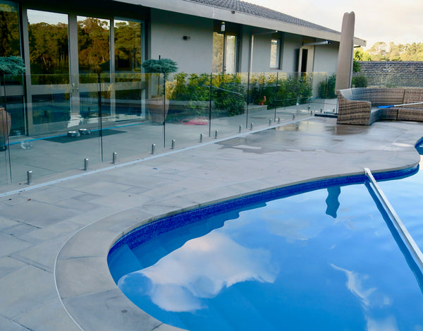 glass pool fencing around swimming pool area